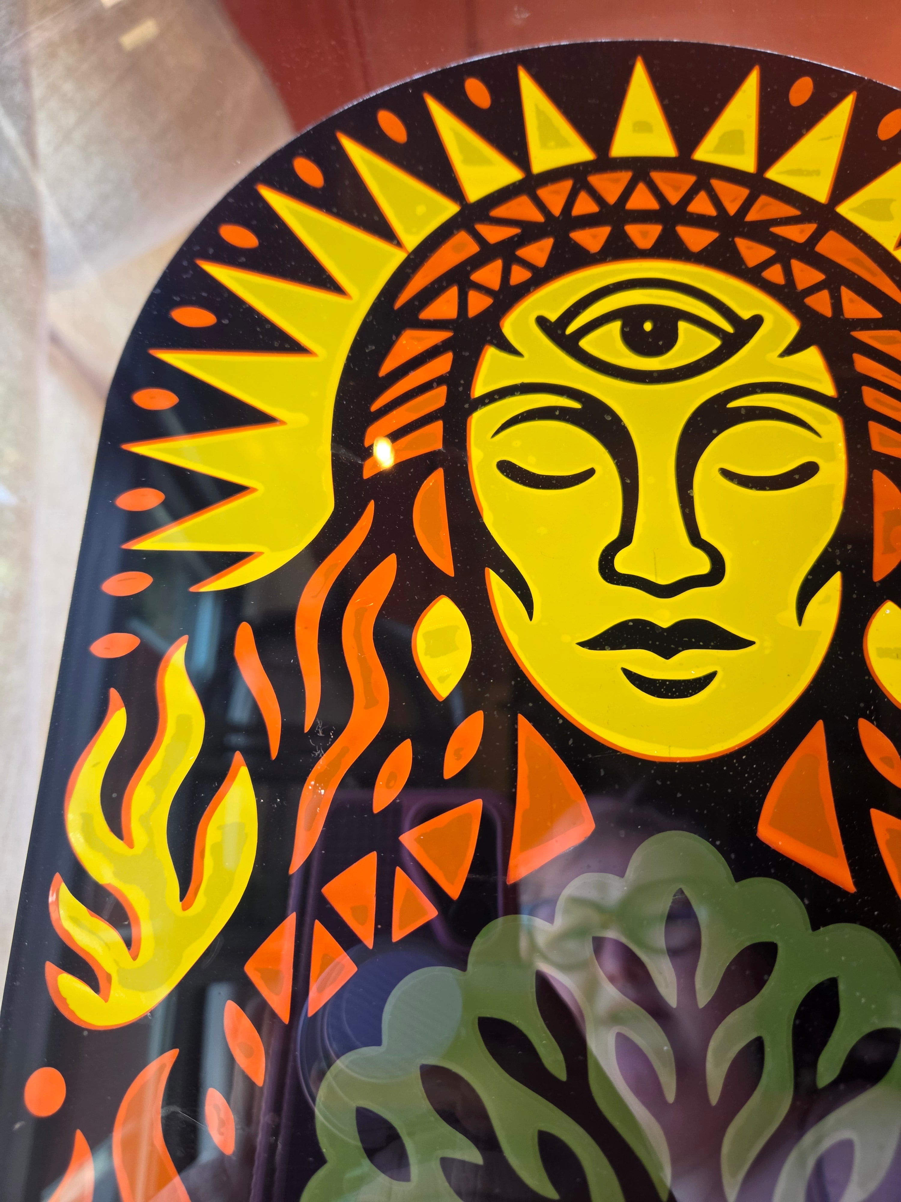 Layered cut-vinyl sun decal on the treeHAUS door