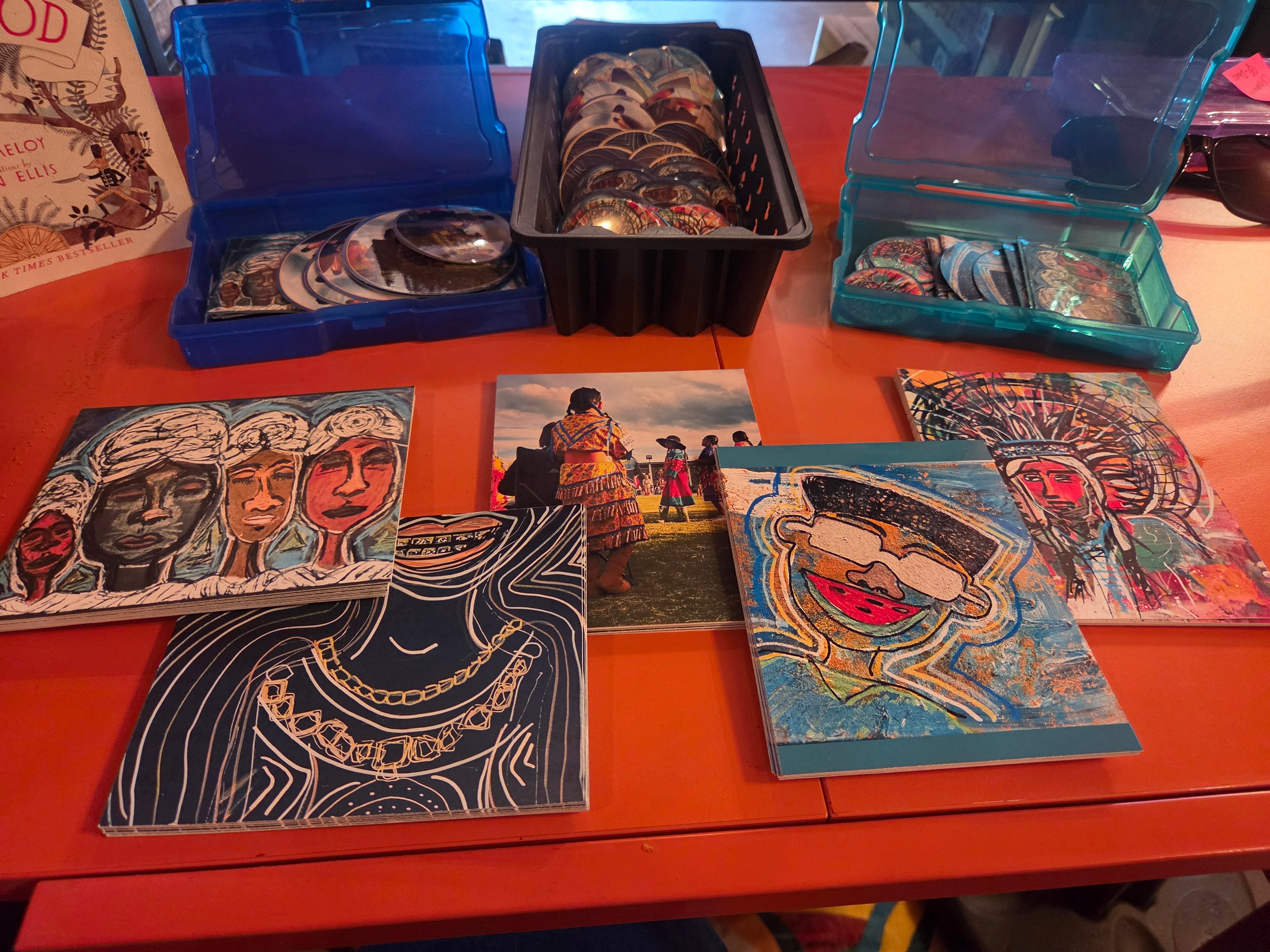 Postcards, buttons and magnets printed from an artist client’s work