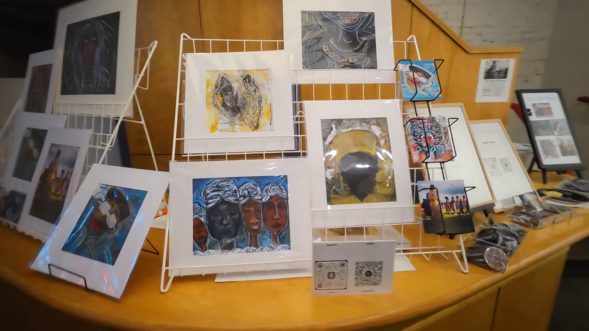 The merchandise and art print table at The Stories We Carry exhibition